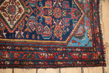 Vivid aqua blue spandrel and madder red border patterns on this vintage Hamadan rug corner.