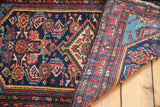Vintage Persian Hamadan rug revealing aqua blue spandrel and geometric red border.