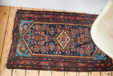 1940s Hamadan corner highlights vivid aqua spandrel, indigo field, and madder red borders.