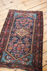 Vintage Hamadan rug featuring vivid aqua spandrel, madder red border, and fringe details.