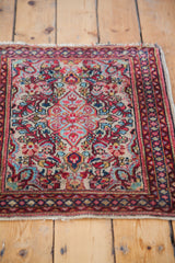 Intricate floral pattern of a Persian Sarouk rug with creamy ivory, aqua, and red.