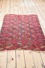 Distressed antique Tekke rug border, featuring geometric motifs in madder red and blue.