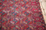 Antique Tekke rug border with ivory star motifs on madder red and distressed field.