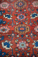 Close-up of the fine, hand-knotted pile and Harshang motifs on an antique Persian Bijar rug.
