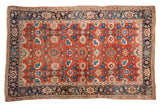 Antique Persian Halvai Bijar rug featuring an allover harshang design with blue and rose motifs on a rust-red field.