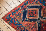 Visible irregularity in the hand-knotted geometric border of an antique Kurdish rug.