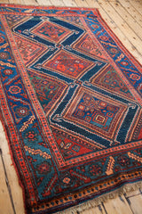 Kurdish tribal rug with unique border construction and bold geometric diamond motifs.