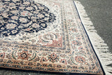 Intricate borders and clean ivory fringe detail of a formal Persian design rug.