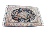 Vintage Pak Persian rug with a traditional medallion, dark navy floral field, soft ivory border, 4'7