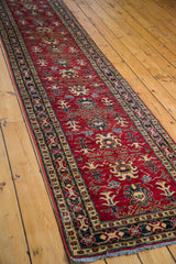 Geometric pattern and detailed border of the vintage red Pak Caucasian runner.