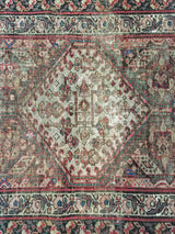 Fine distressed texture on the antique Persian runner, with muted reds, blues, and ivory patterns.