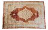 Antique silk Tabriz mat with a burgundy medallion on an ivory field and soft blue borders.