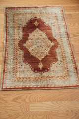 Antique silk Haji Jalili Tabriz rug with a time-softened patina and central medallion design.