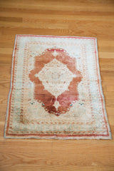 A full perspective of the antique silk Tabriz mat, showing its delicate wear and complete medallion design.
