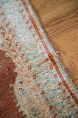 Close-up of the worn edge and fine knotting on an antique silk Persian Tabriz rug.