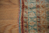 The worn side cord and finely woven silk pile of an antique Tabriz border.