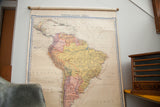 Vintage Denoyer Geppert South America map with subtle pink, yellow, off-white colors and aged patina.
