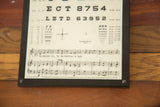 Detail of antique eye chart plaque by Matelene, with 1935 copyright and musical score.