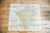 Overall view of a circa 1920s France map, with subtle pastel tones and rich patina from age.