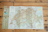 Vintage tourist road map of Switzerland showing its full layout, soft colors, and a graphic legend.