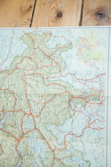 Close-up showing the soft green topography and red road network of a vintage Switzerland map.