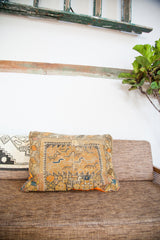 Early 20th-century geometric rug fragment forms this vibrant orange and yellow pillow.