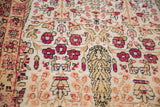 Artfully distressed antique Kerman carpet pile showing detailed cypress tree and ruby floral motifs.