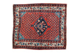 Vintage Engelas mat with a navy diamond medallion on a rich red field and floral border.