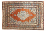 Fine antique Haji Jalili Tabriz rug with a rust orange field, intricate central medallion, and aqua blue details.