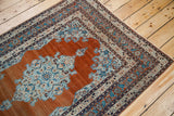 Delicate outlines of the aqua blue floral medallion corner on a fine antique Tabriz rug.