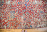 Brilliant grapefruit red Sultanabad fragment features ivory and blue allover design with wear.