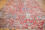 Sultanabad fragment rug in brilliant grapefruit red with allover light ivory, blue, and green.