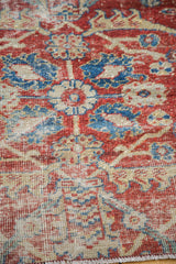 Textural detail of Sultanabad fragment showing grapefruit red, blue, ivory pattern, secured foundation.