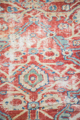 Grapefruit red, ivory, blue, and green motifs on the worn Sultanabad fragment pile.