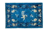 Antique Chinese Peking rug: vivid cobalt blue field, central phoenix, blossoming lotus flowers, 2'1