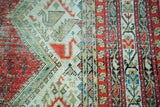 Distressed geometric patterns, raspberry, ivory, and blue-green border of antique Malayer runner.