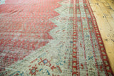 Distressed raspberry cinnabar red Mir-boteh design with ivory and soft blue of the antique Malayer rug.