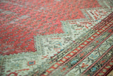 Distressed Mir-boteh pattern, raspberry red, and ivory border on an antique Malayer rug.