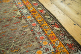 Antique Northwest Persian runner's geometric orange borders and textured, distressed field.
