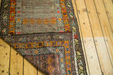Intricate geometric borders and visible hand-knotted reverse of an antique runner.