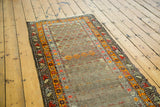Antique runner border with vibrant orange geometric motifs and distressed beige field.