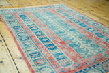 Distressed texture and striped pattern of vintage Turkish rug in raspberry, seafoam, aqua.