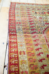 Vintage distressed Turkish rug's secured side border with vivid geometric patterns.