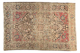 Antique Farahan Sarouk rug with a charcoal medallion, raspberry spandrels, and a beige floral field.