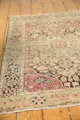Raspberry and charcoal corner spandrel of an antique Persian Farahan Sarouk carpet.