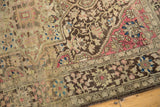 Angled close-up of an antique Farahan Sarouk corner with raspberry, charcoal, and beige motifs.