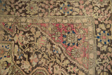 Antique Farahan Sarouk rug corner showing raspberry, charcoal, and powder blue floral motifs.