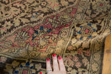 Pliable weave of a Farahan Sarouk rug showing raspberry, charcoal, and blue floral motifs.