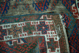 Antique Jaff Kurd rug: geometric motifs, brilliant jewel tones, and storied, distressed wool texture.