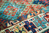 Storied texture and brilliant jewel-tone geometric motifs in the distressed Jaff Kurd wool pile.